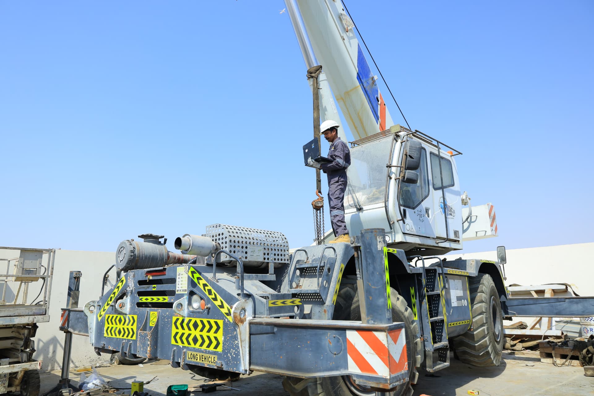 AutoDome engineer performing diagnostics on a mobile crane carrier